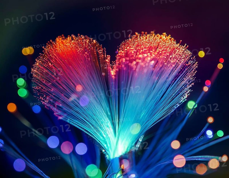 Colorful artistic display featuring vibrant light patterns shaped like a heart, expressing love and creativity through illuminated fibers in a mesmerizing spectrum of rainbow hues, AI generated