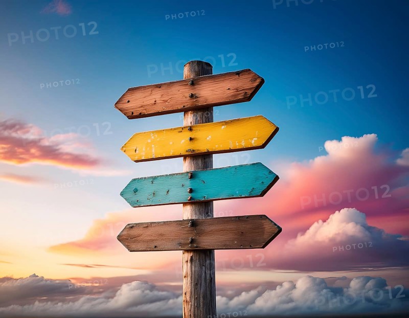 Rustic wooden direction signs painted in vibrant colors with a beautiful sunset background evoking exploration and travel, AI generated
