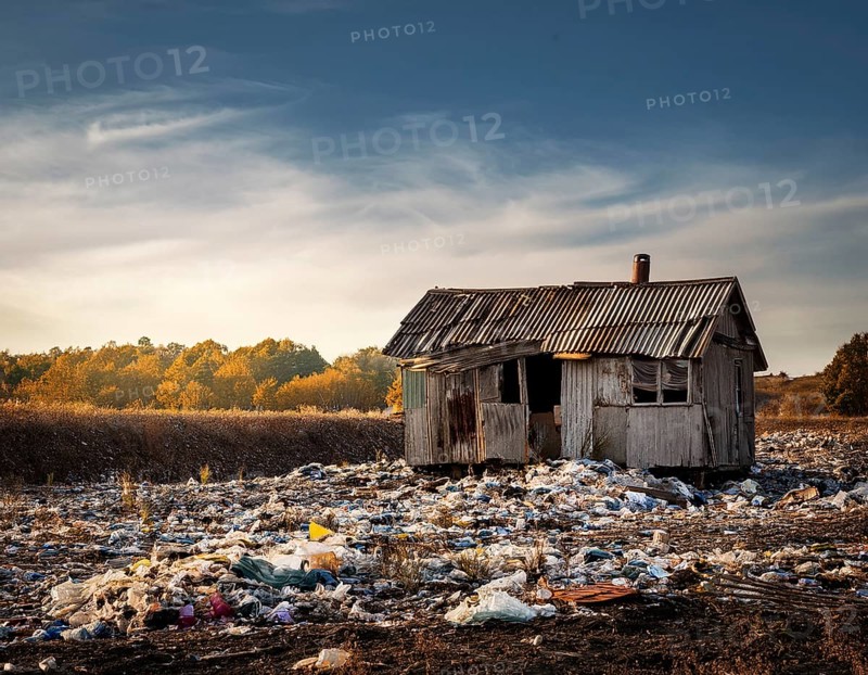 An abandoned house sits amidst scattered garbage in a deserted rural area, conveying environmental degradation. The scene embodies neglect, waste accumulation, and ecological crisis in a starkly barren setting, AI generated