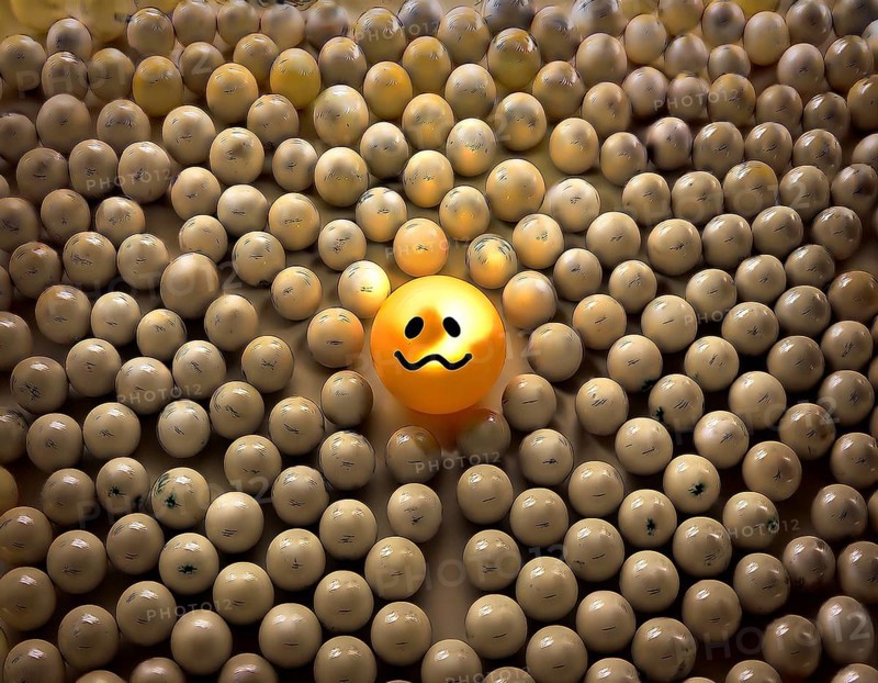 Wooden balls feature faces, one smiling among sad expressions, representing positivity or individuality, AI generated