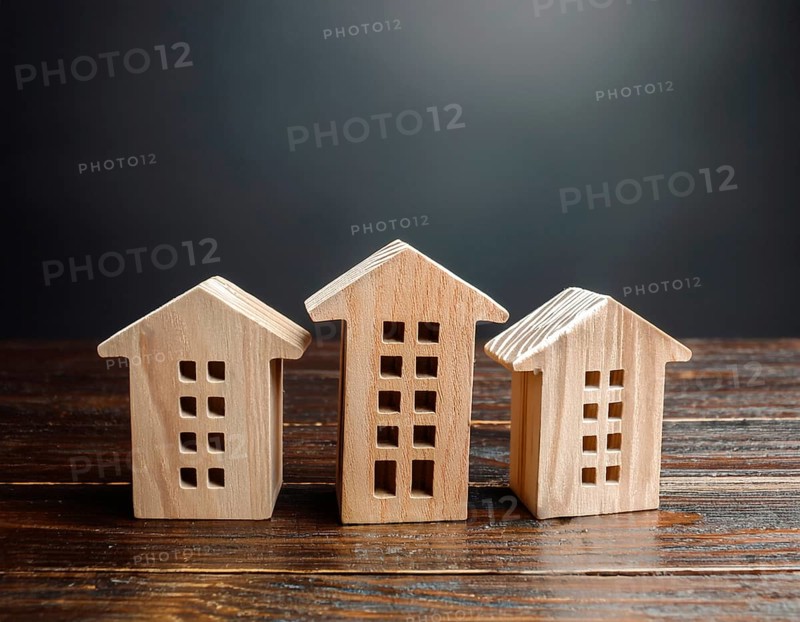 A collection of small wooden model houses with cozy lighting, creating a warm and inviting atmosphere, AI generated