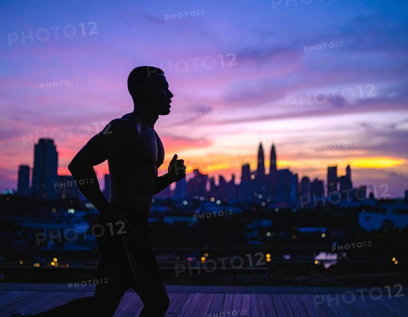 A cinematic silhouette of an athletic man running, representing fitness, endurance, wellness, and healthy active living, AI generated