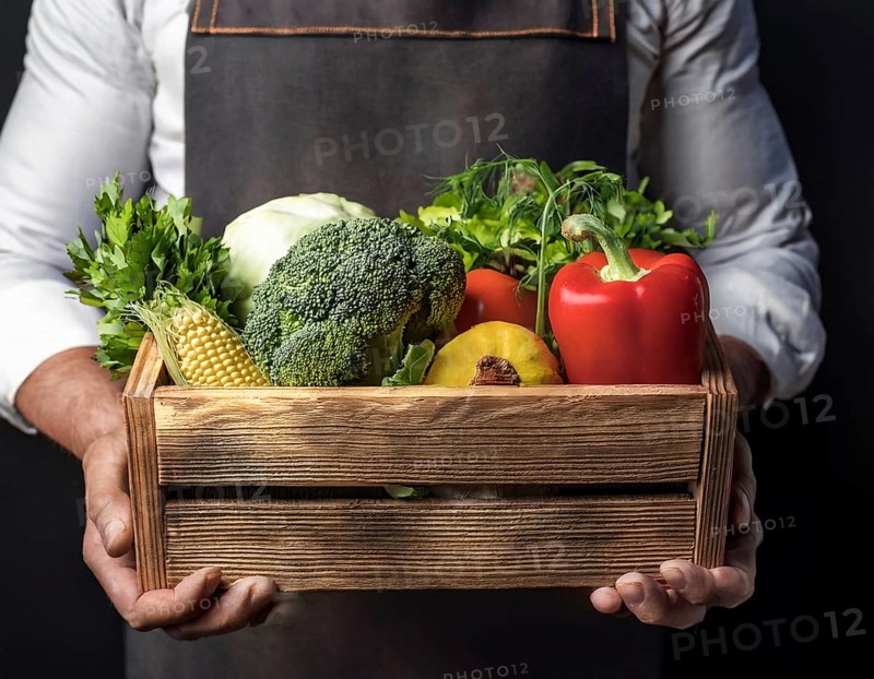 Man holding wooden crate with vegetables. Wooden box filled with fresh food products and ready for delivery, AI generated