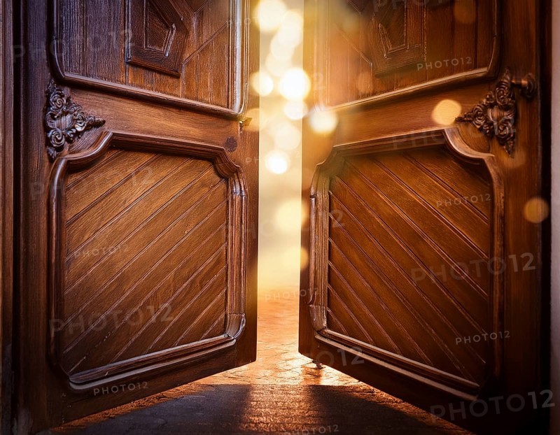 Vintage door ajar in the middle with glowing magical warm lights on the other side, AI generated