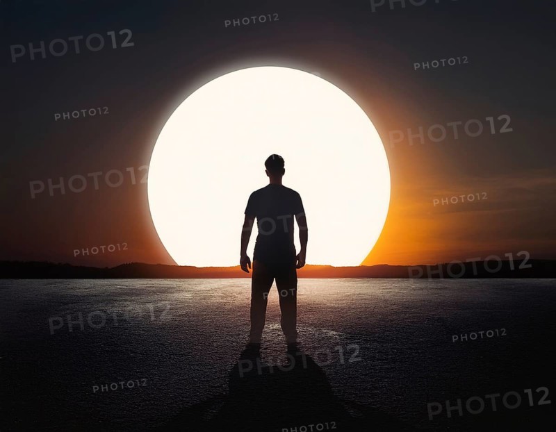 Man silhouette against giant glowing sun symbolizing inspiration, destiny, reflection, cosmic power, and natural wonder, AI generated