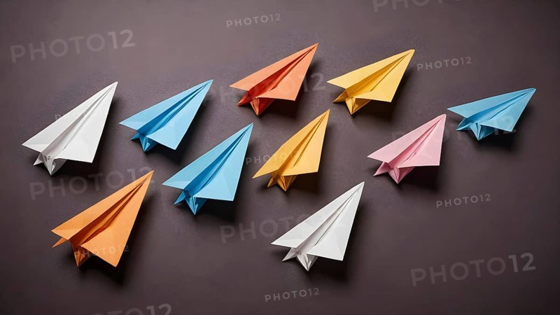 Colorful paper planes arranged in organized pattern, symbolizing creativity, playfulness, imagination, and artistic decorative concepts, AI generated