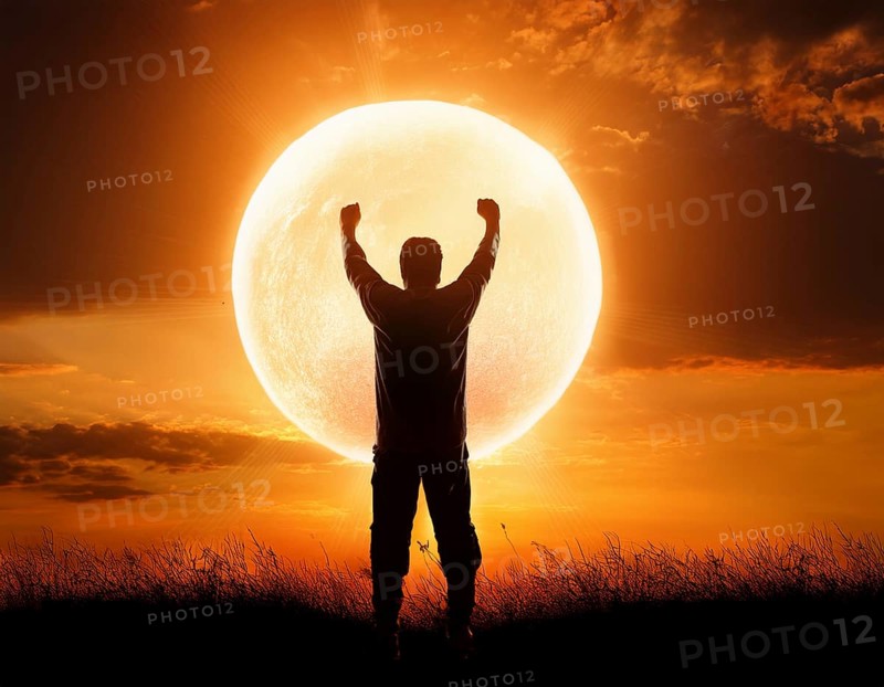 Man silhouette against giant glowing sun symbolizing inspiration, destiny, reflection, cosmic power, and natural wonder, AI generated