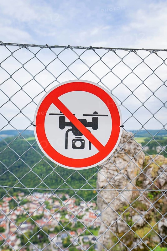 Sign on the fence indicating a drone ban, with a view of the landscape below, Lichtenstein Castle, Lichtenstein, Swabian Alb, Germany