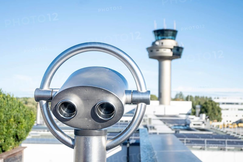 Binoculars for visitors aimed at the tower of Salzburg Airport, Austria