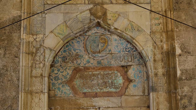 Decorated arch with faded inscriptions and ornaments on a stone background, Recep Pasha Mosque, Old Town, Turkish Quarter, Rhodes Town, Rhodes, Dodecanese, Greek Islands, Greece