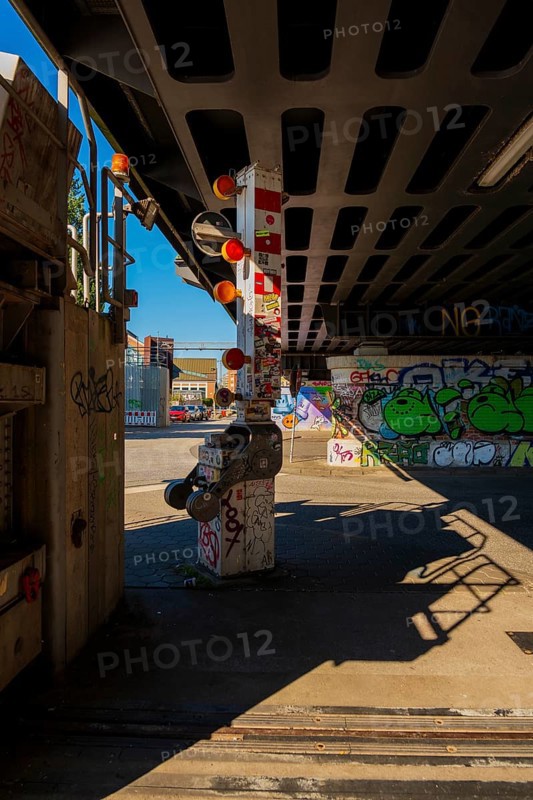 Stickered and graffiti-painted barrier used to block the Oberhafen Bridge, Hamburg, Germany