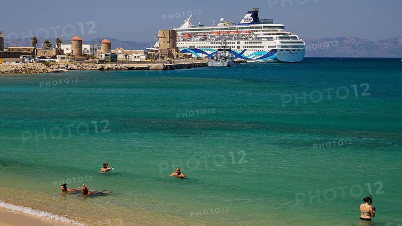 Large cruise ship in the harbour near a beach with turquoise water and bathers, Sachtouri Beach, Rhodes Old Town, Rhodes Town, Rhodes, Dodecanese, Greek Islands, Greece