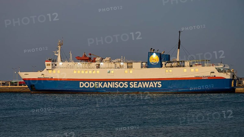 A Dodekanisos Seaways ferry docks at dusk in the harbour by the calm sea, Rhodes Old Town, Rhodes Town, Rhodes, Dodecanese, Greek Islands, Greece