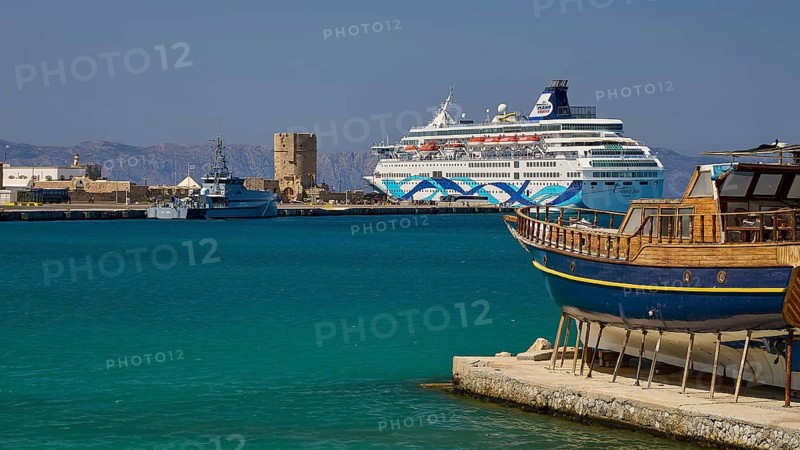 Coastal view with traditional boat and cruise ship in the harbour in sunny weather, Rhodes Old Town, Rhodes Town, Rhodes, Dodecanese, Greek Islands, Greece