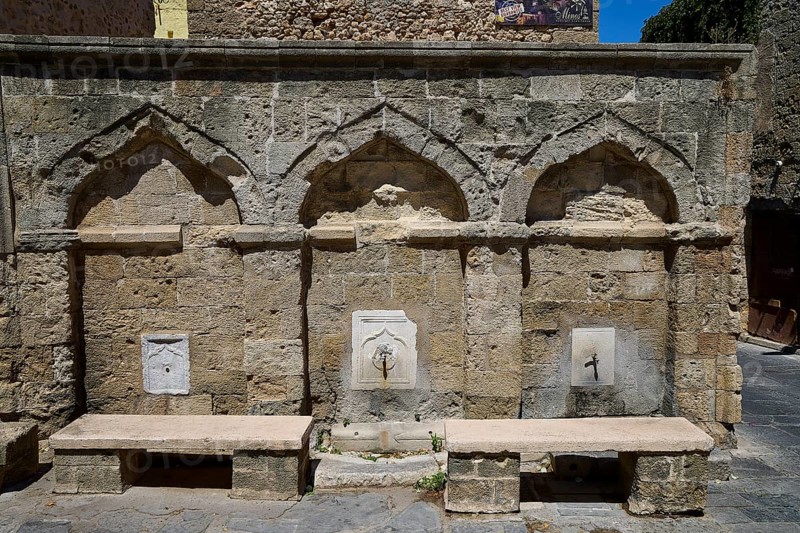 Fountain, washing facilities, near Borsani Mosque, Omirou Street, Ancient sandstone structure with three arches and a decorative water fountain, flanked by stone benches, Rhodes Old Town, Rhodes Town, Rhodes, Dodecanese, Greek Islands, Greece