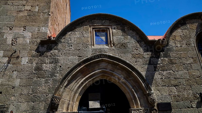 Kasteliani Public Library, Italian coat of arms, Historic stone gate under a clear blue sky, Rhodes Old Town, Rhodes Town, Rhodes, Dodecanese, Greek Islands, Greece