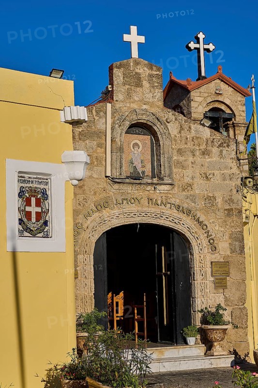 Church of Agios PanteleimoChurch entrance with icon painting and crosses, yellow wall in the foreground, Rhodes Old Town, Rhodes Town, Rhodes, Dodecanese, Greek Islands, Greece