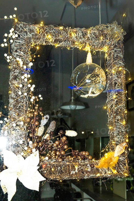 Festive christmas decoration illuminating a shop window in bayonne, france, creating a warm and inviting atmosphere