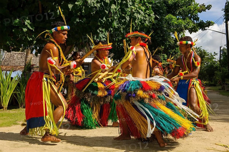 Traditional group of dancers from Yap Island dancing in historical traditional costume with headdress performing traditional ritual bamboo dance stick dance with bamboo sticks ritual, Yap Island, Yap State, Caroline Islands, FSM, Federated States of Micronesia, Australia, Oceania