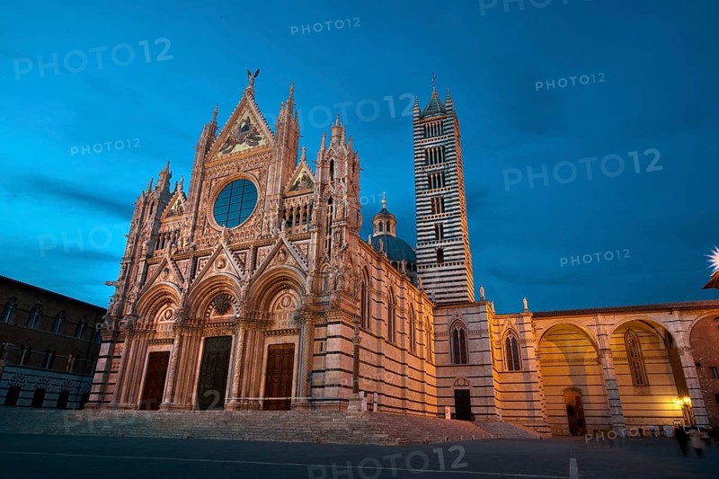 Illuminated Duomo illuminated cathedral of Siena Cattedrale Metropolitana di Santa Maria Assunta at dusk blue hour, Siena, Tuscany, Italy