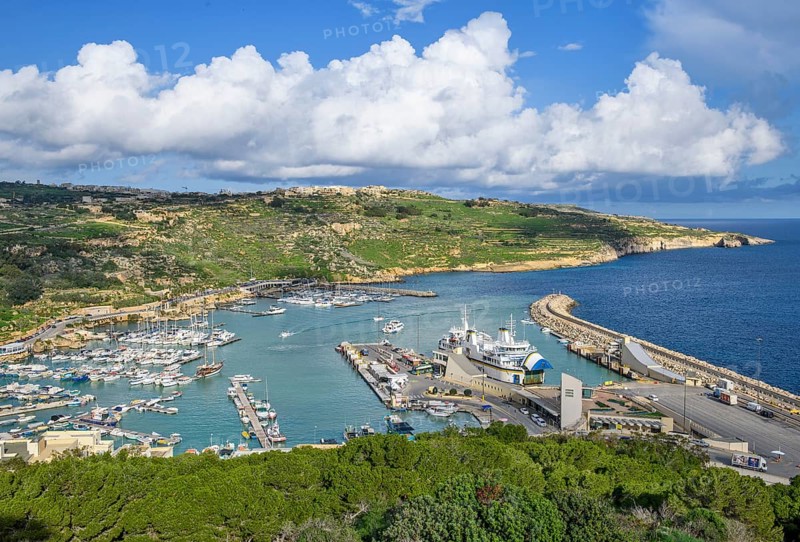 View of Gozo Mgarr Harbour harbour basin with small boats yachts yachts on the left, in the centre of the picture jetty for ferries from Valletta island Malta and moored ferry car ferry, Mgarr, Gozo, Malta