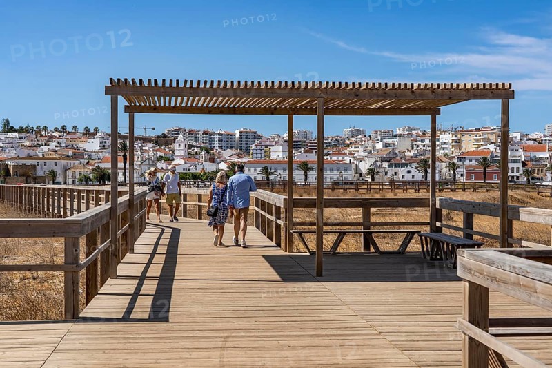 The skyline of the historic centre of Lagos, on the river Bensafrim, view from the boardwalk on the opposite beach Praia de São Roque, in the west of the Algarve, Portugal