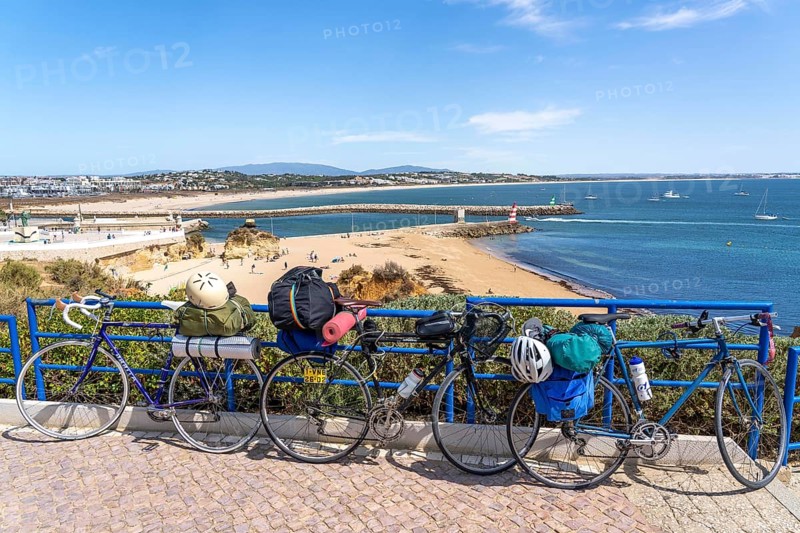 Bicycles with luggage, above the beach Praia da Batata, in the city centre of Lagos, in the west of the Algarve, Portugal
