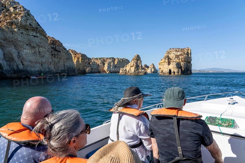 Tour with a small motorboat to the Ponta da Piedade rocky coast, rugged coastal landscape, right next to the city centre of Lagos, in the west of the Algarve, Portugal