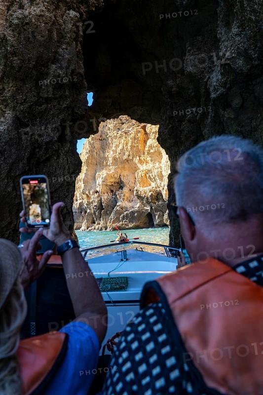 Tour with a small motorboat to the Ponta da Piedade rocky coast, rugged coastal landscape, right next to the city centre of Lagos, in the west of the Algarve, Portugal