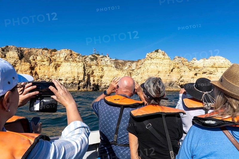 Tour with a small motorboat to the Ponta da Piedade rocky coast, rugged coastal landscape, right next to the city centre of Lagos, in the west of the Algarve, Portugal