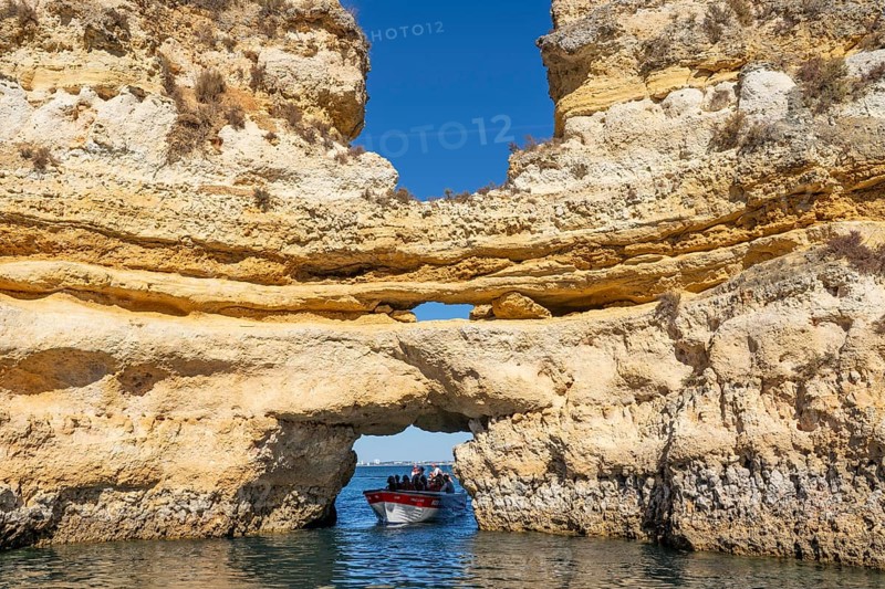Tour with a small motorboat to the Ponta da Piedade rocky coast, rugged coastal landscape, right next to the city centre of Lagos, in the west of the Algarve, Portugal