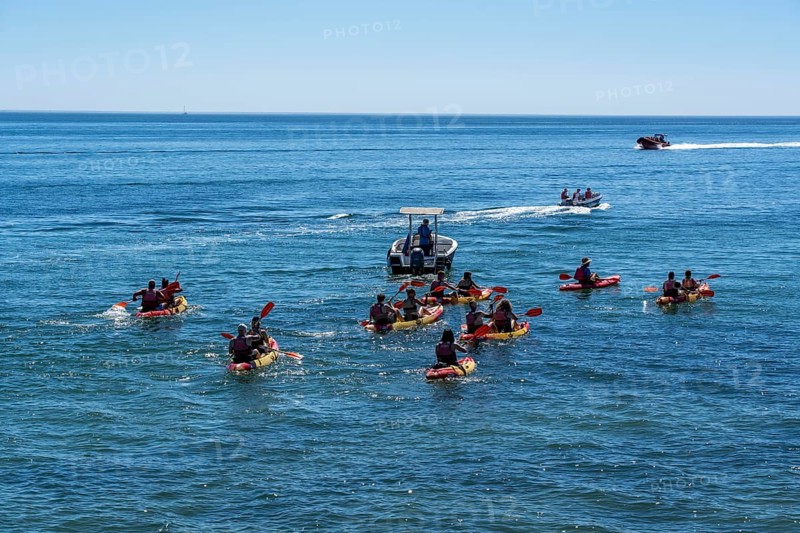 Kayak tours to the rocky coast of Ponta da Piedade, groups of tourists kayak on the sea to the rugged coastline of Lagos, in the west of the Algarve, Portugal