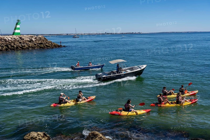 Kayak tours to the rocky coast of Ponta da Piedade, groups of tourists kayak on the sea to the rugged coastline of Lagos, in the west of the Algarve, Portugal