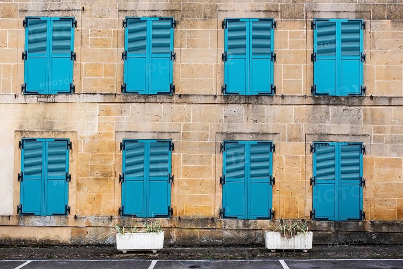 Closed, green shutters, historic house facade, yellow sandstone, Marville, Renaissance village, Département Meuse, Grand Est, France