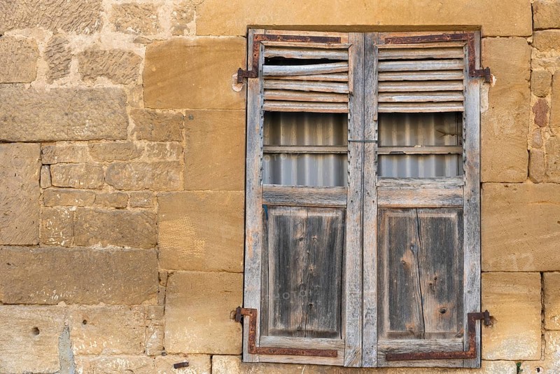 Closed wooden window, historic house facade, yellow sandstone, Marville, Renaissance village, Département Meuse, Grand Est, France