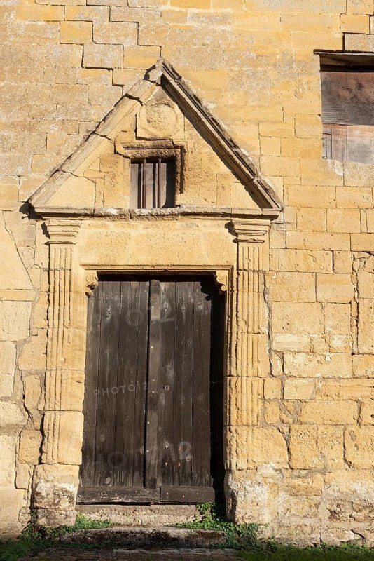 Wooden door, historic house façade, yellow sandstone, Marville, Renaissance village, Département Meuse, Grand Est, France