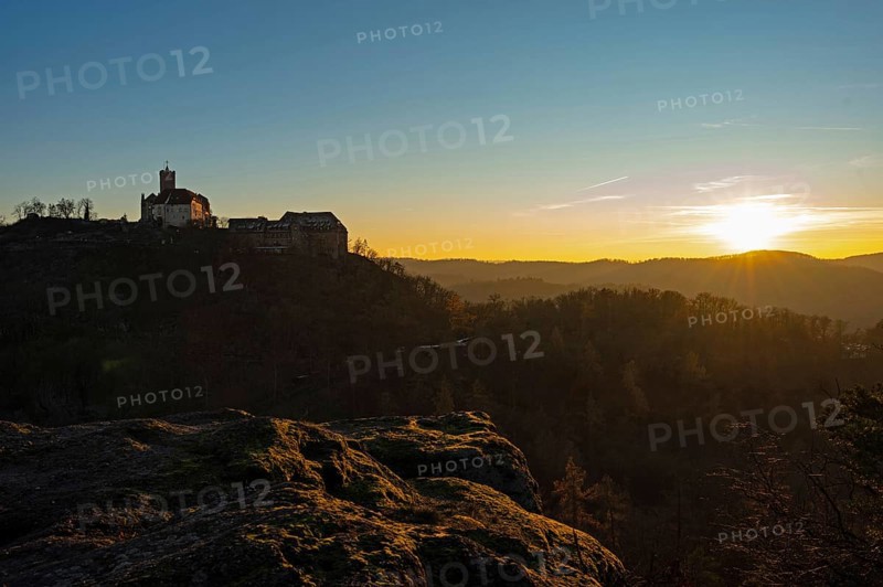 View of Wartburg Castle with the setting sun and the Thuringian Forest, Eisenach, Thuringia, Germany
