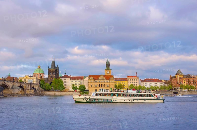 View of old town with Charles Bridge (Karluv Most) on Vltava river and Old Town Bridge Tower, famous tourist destination in Prague, Czech Republic (Czechia), at sunset