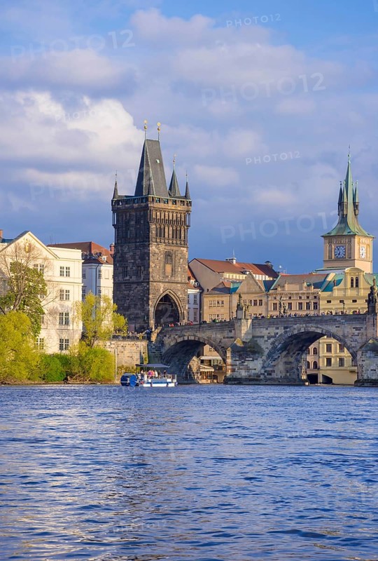 Charles Bridge (Karluv Most) on Vltava river and Old Town Bridge Tower, famous tourist destination in Prague, Czech Republic (Czechia), at sunset