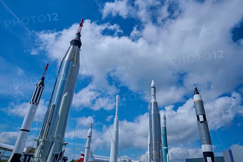 Various rockets rising into the blue sky, surrounded by clouds, Kennedy Space Centre Visitor Complex, Merritt Island, Florida, USA