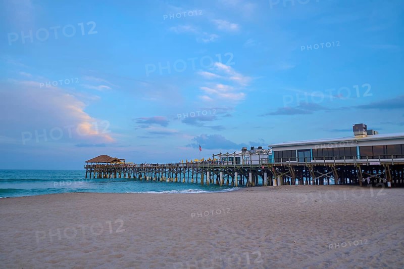 A quiet beach with a long wooden pier under a blue evening sky, Westgate Cocoa Beach Pier, Cocoa Beach, Port Canaveral, Florida, USA