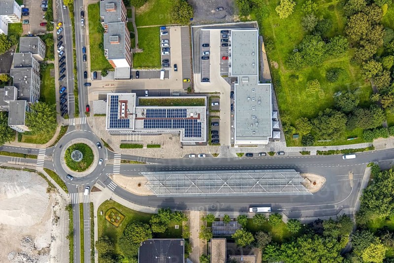 Aerial view, bus station with roundabout and savings bank building with solar roof in Schönhausen, Bergkamen, Ruhr area, North Rhine-Westphalia, Germany, authority, bus station, bus station roof, DE, Europe, roundabout, roundabout, aerial view, aerial photography, aerial photography, photovoltaic, photovoltaic system, town hall, solar, solar system, solar roof, solar energy, city administration, overview, bird's eye view, birds-eyes view, overview