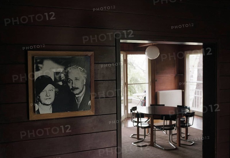 Potsdam-Caputh, DEU, Germany. 26.04.2002 - Albert Einstein's summer residence: living room of the famous scientist. Photo of the Einstein couple. (table, interior, furniture, interior, history, museum) -