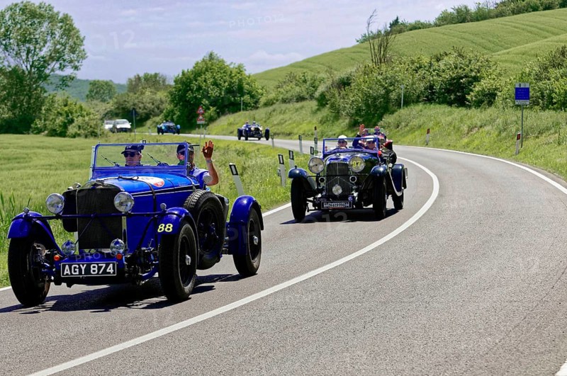 Two blue classic cars driving one behind the other on a winding country road, classic car, car race, Mille Miglia, 1000 Miglia, 2015, Tuscany, Rome Lake Garda, Italy