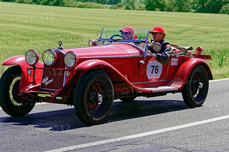 A classic red vintage car with two drivers on a country road, vintage car, car race, Mille Miglia, 1000 Miglia, 2015, Tuscany, Rome Lake Garda, Italy