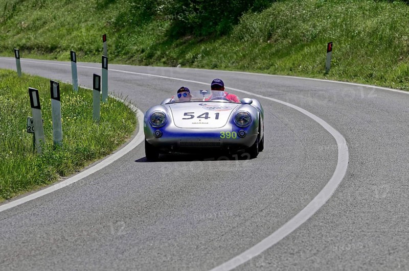 A silver racing car with two people drives swiftly along a winding road, classic car, car race, Mille Miglia, 1000 Miglia, 2015, Tuscany, Rome Lake Garda, Italy