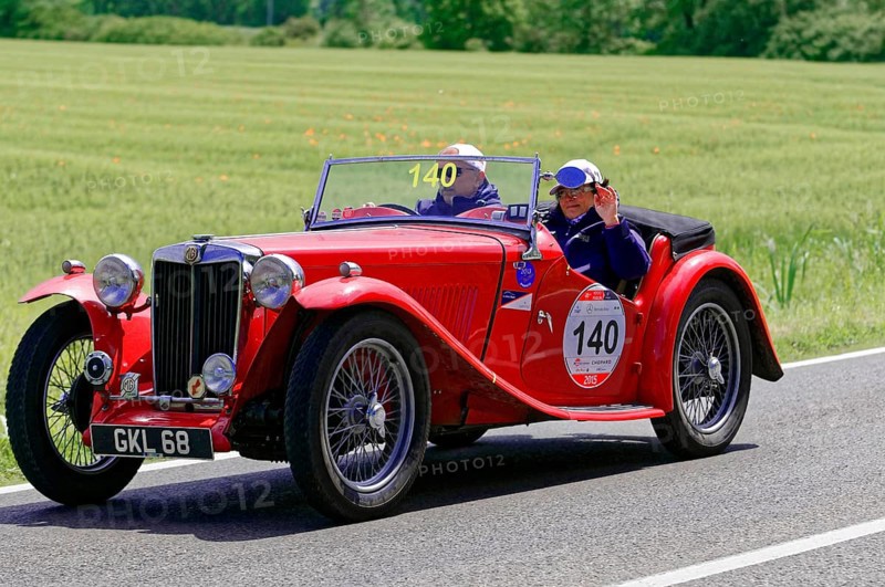 A red classic roadster drives along a rural road in fine weather, classic car, car race, Mille Miglia, 1000 Miglia, 2015, Tuscany, Rome Lake Garda, Italy