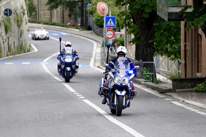 Police motorbikes driving on a road, accompanied by traffic signs, Mille Miglia 2014 or 1000 Miglia, vintage car race, San Marino, Italy