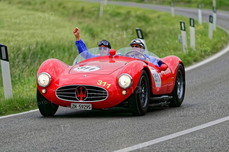 Two people driving in a red Maserati classic car on a winding country road, classic car, car racing, Mille Miglia, 1000 Miglia, 2015, Tuscany, Rome Lake Garda, Italy