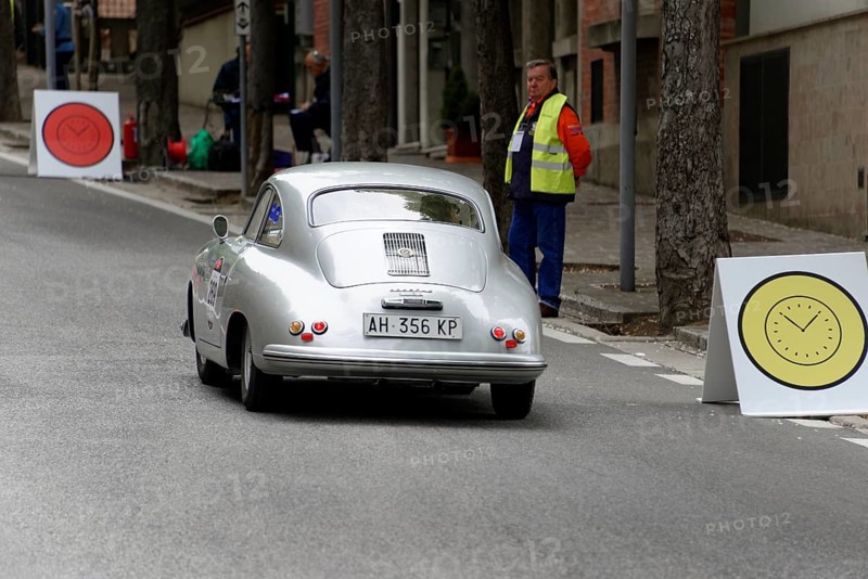 No. 269, Porsche 356 1500, model year 1953, Silver car drives past targets with large signs, a person watches at the side of the road, Mille Miglia 2014 or 1000 Miglia, classic car race, San Marino, Italy